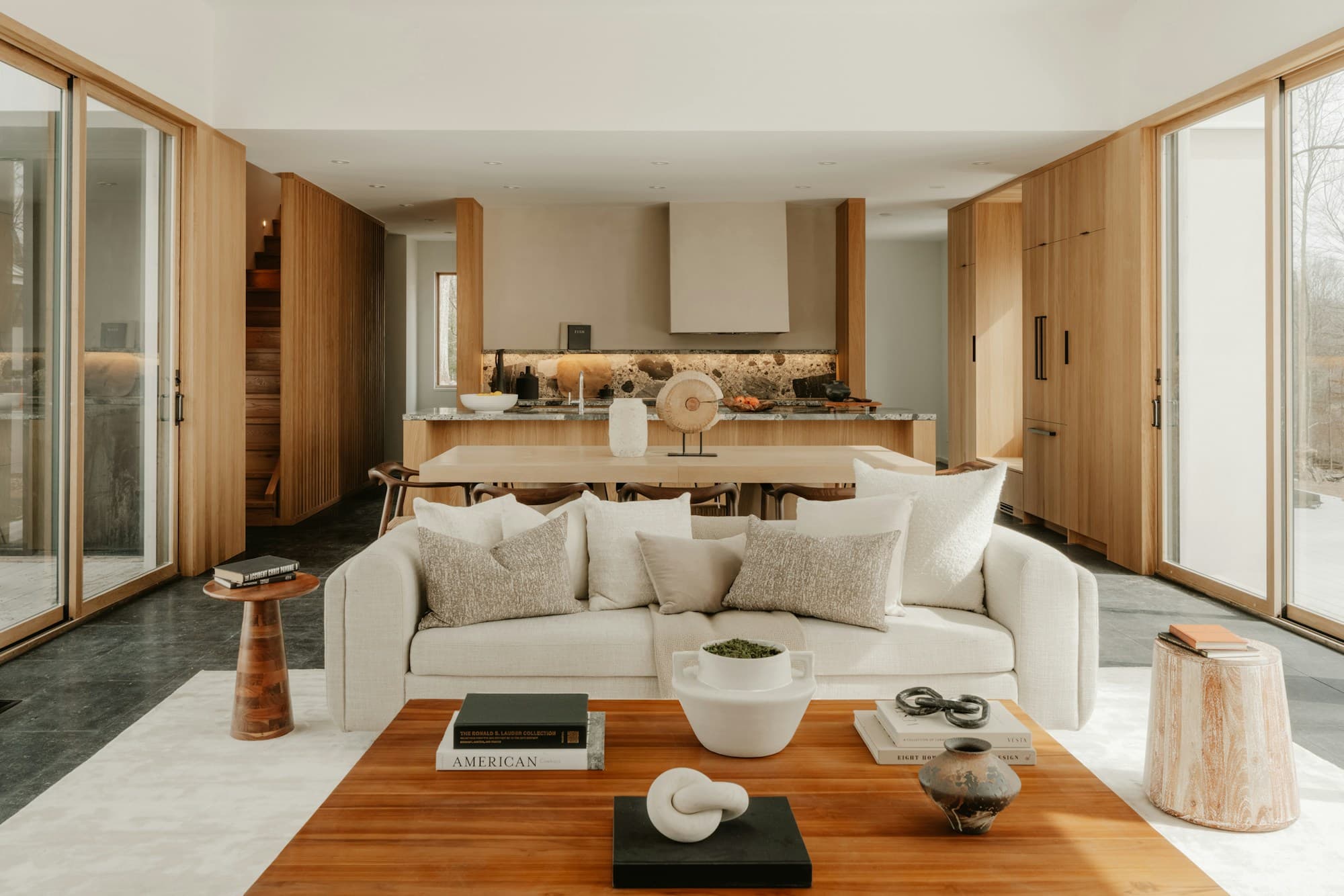 Warm, wood-lined living room with sliding glass walls